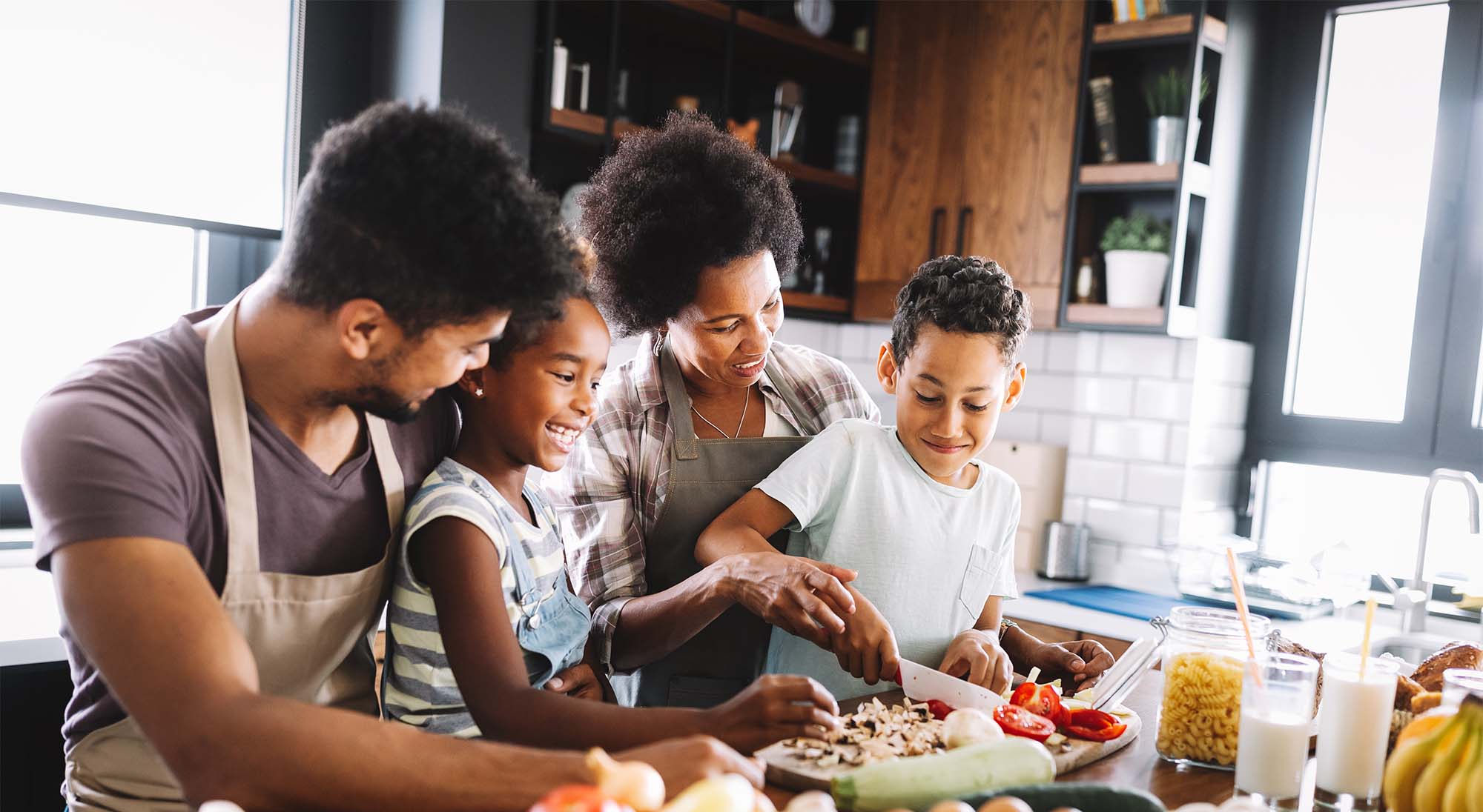 Family cooking healthy food together in a really nice kitchen
